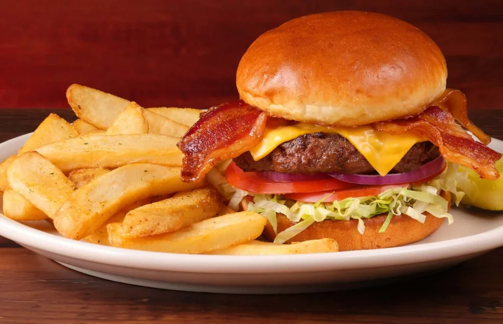 bacon cheeseburger served with brown fries 