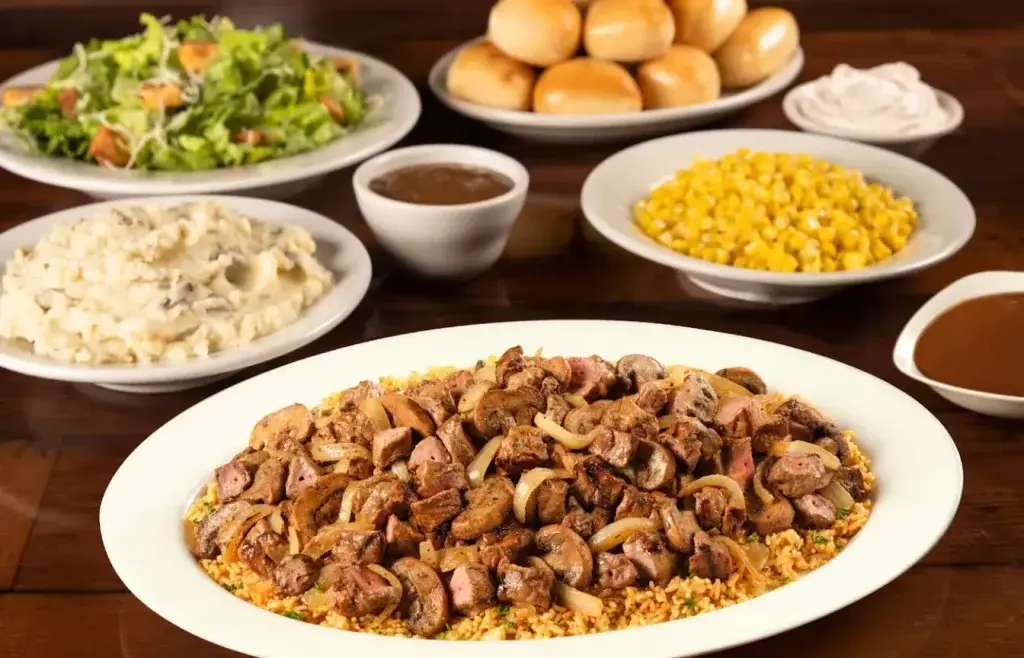Family-sized beef tips with buttered corn, fresh salad, mashed potatoes and dip sauce 