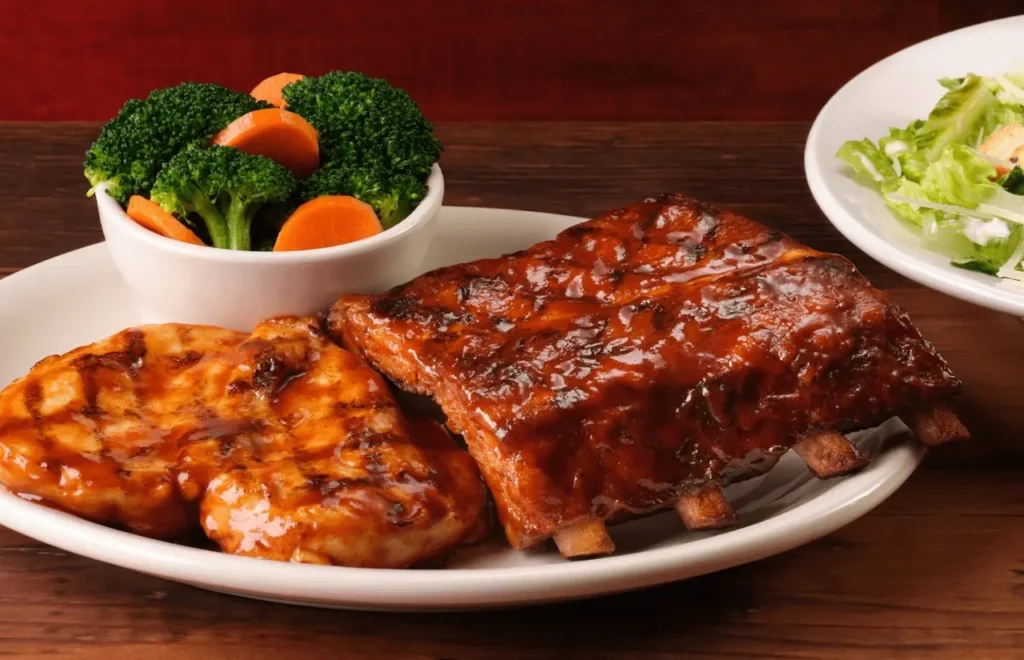 couple of grilled BBQ chicken with half slab of ribs, served with fresh steamed broccoli