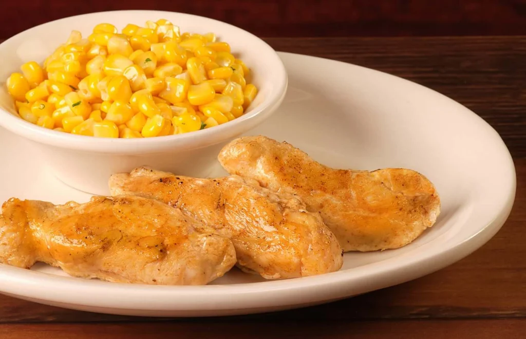 Crispy kids' grilled chicken served with buttery corn