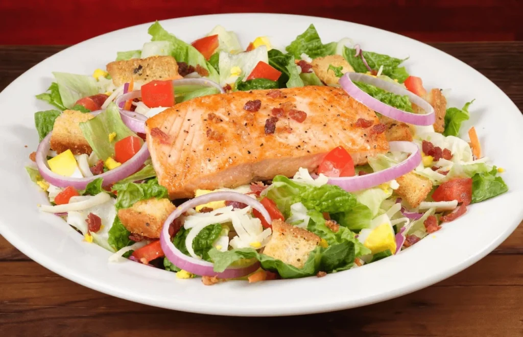 Grilled salmon salad over mixed greens with lemon-herb drizzle