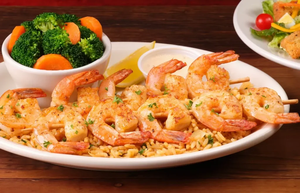 Grilled shrimps on rice served with dip sauce and  steamed broccol 