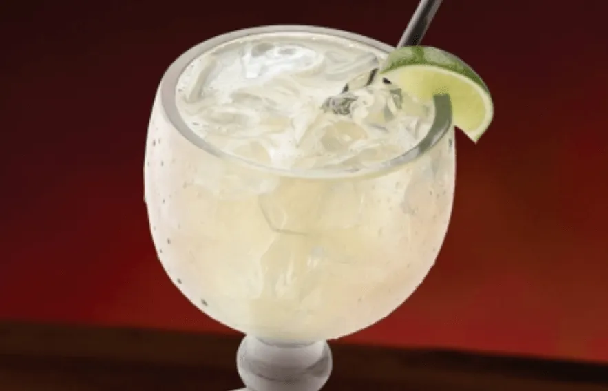 House Rocks Margarita in class with ice and fruit 