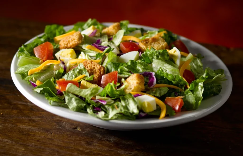 Fresh House Salad with mixed greens, cucumbers, and tomatoes