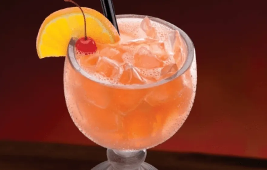 Hurricane margarita filled with ice and garnished with  lemon and cherry