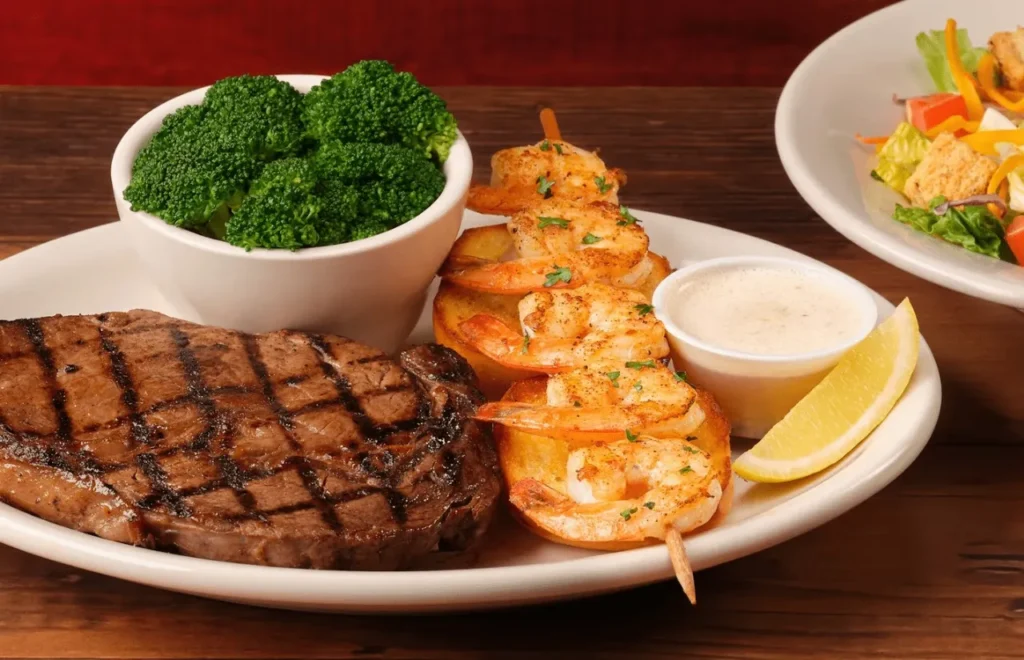 Hearty ribeye with herby grilled shrimps served with green broccoli and dip sauce