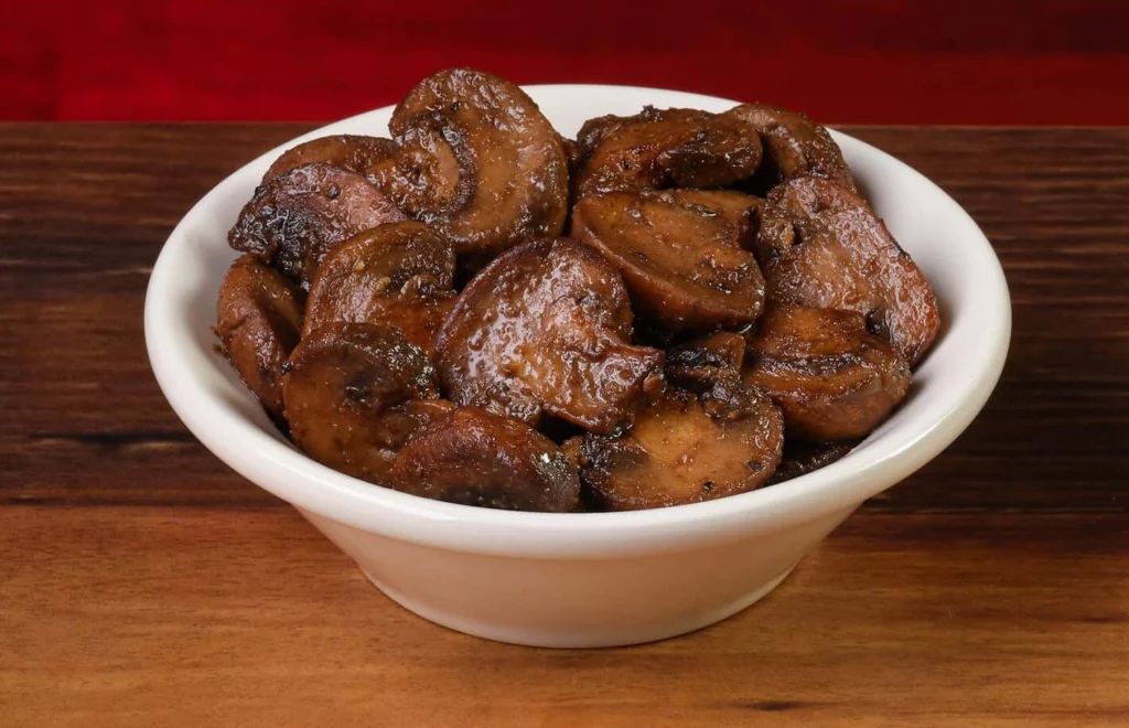 bowl containing sauteed mushrooms