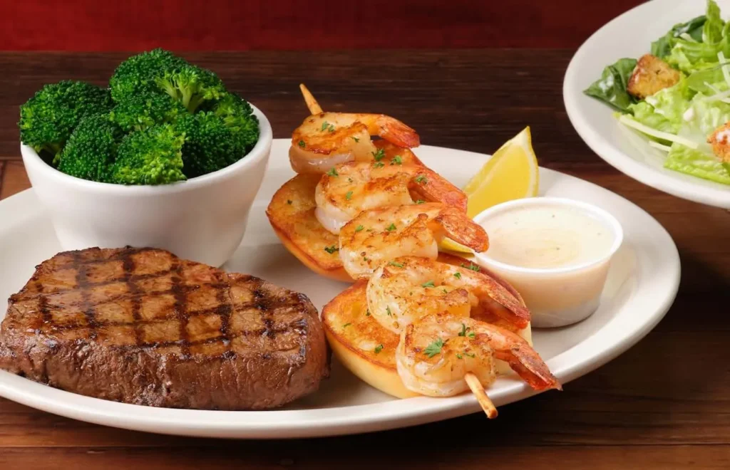 grilled shrimp pairs with juicy sirloin and served with dipping sauce and green broccoli