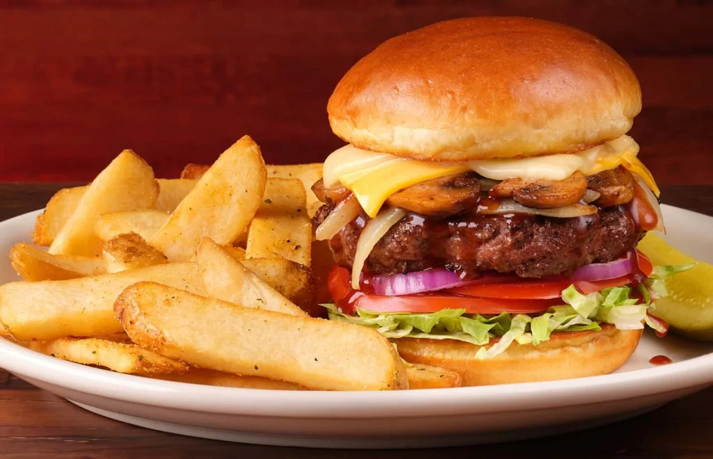 a smokehouse burger with fries on a side