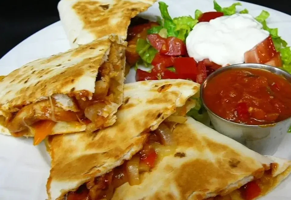 Smokehouse Quesadilla served with red sauce and salad 