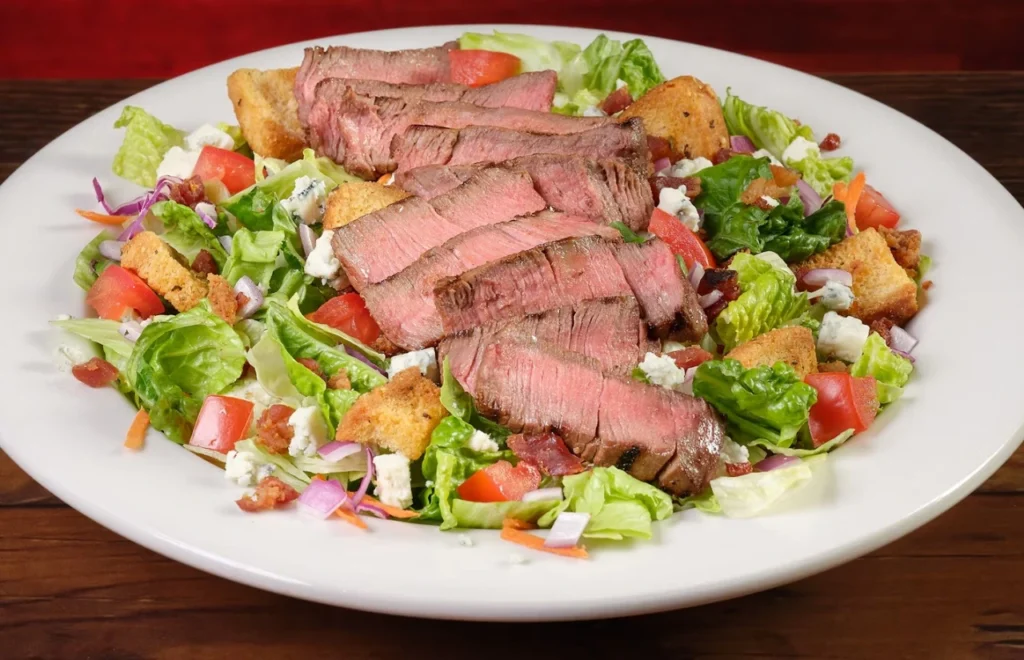 Steakhouse Filet Salad with sliced filet over mixed greens