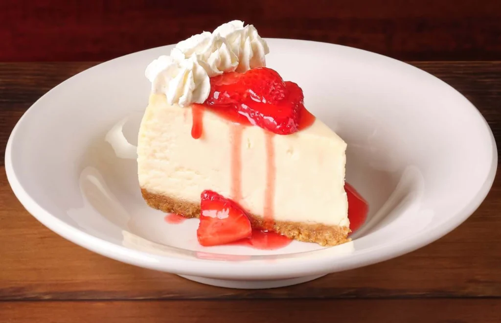 Plate of strawberry cheesecake with sweet topping