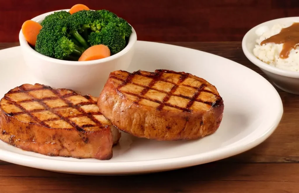 Grilled Pork Chop (single) served with steamed vegetables