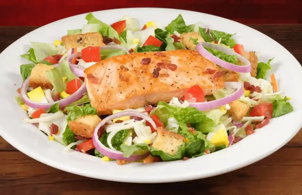 home page 12 Grilled salmon salad over mixed greens with lemon-herb drizzle