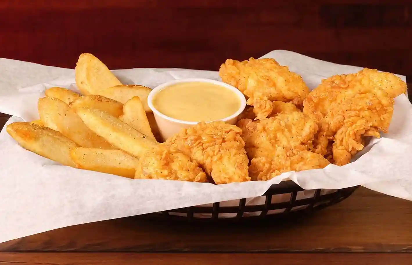 home page 82 Jr. Chicken Tenders served with fries and sauce in basket
