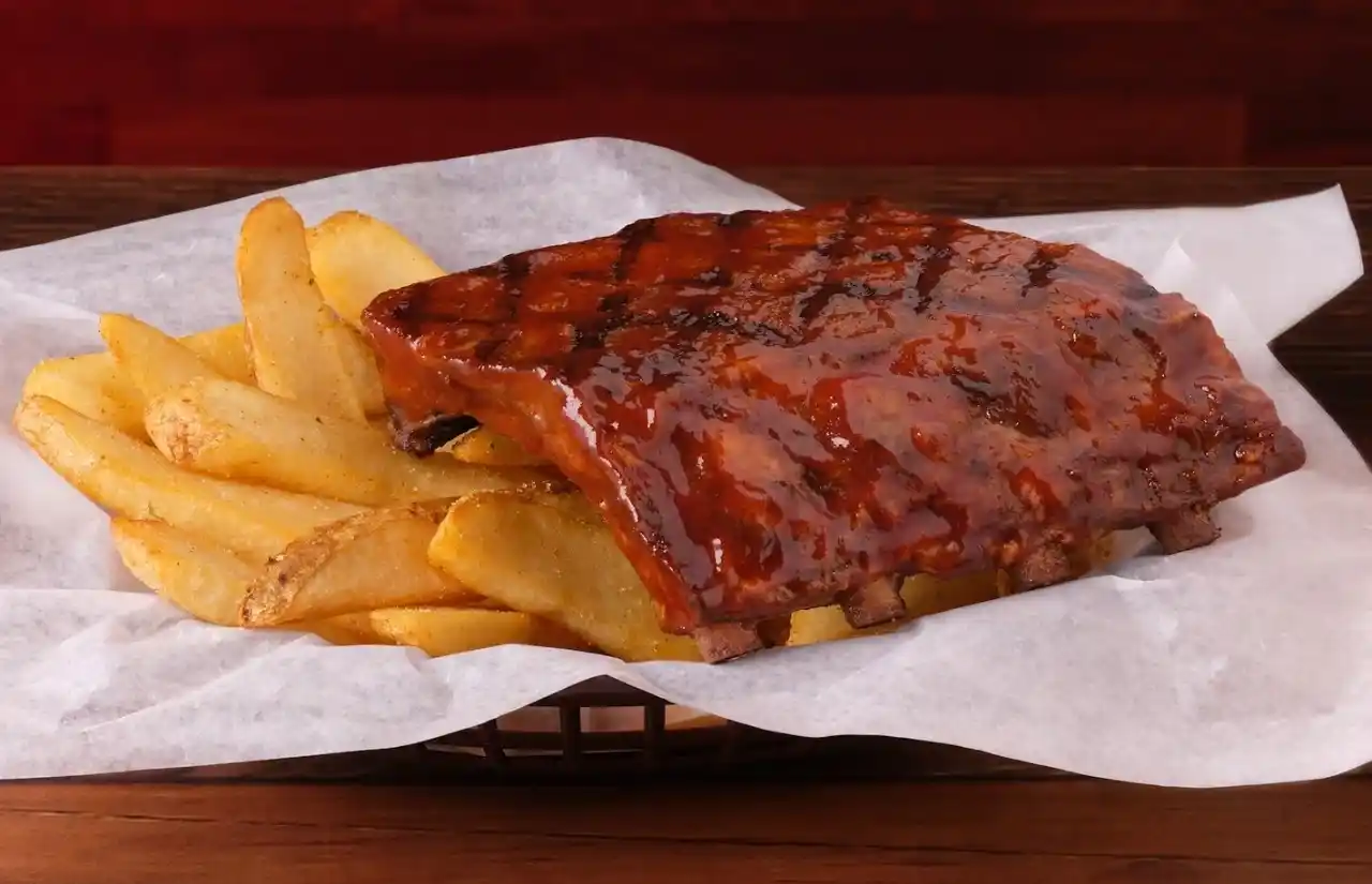 home page 9 Fall-off-the-bone Killer Ribs slathered in smoky BBQ sauce served with brown fries
