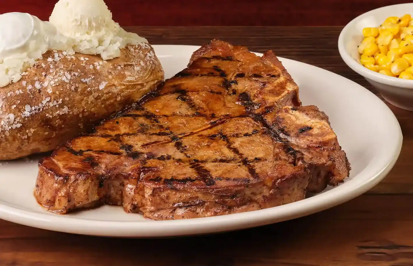 home page 23 Juicy porterhouse T-bone served with baked potato