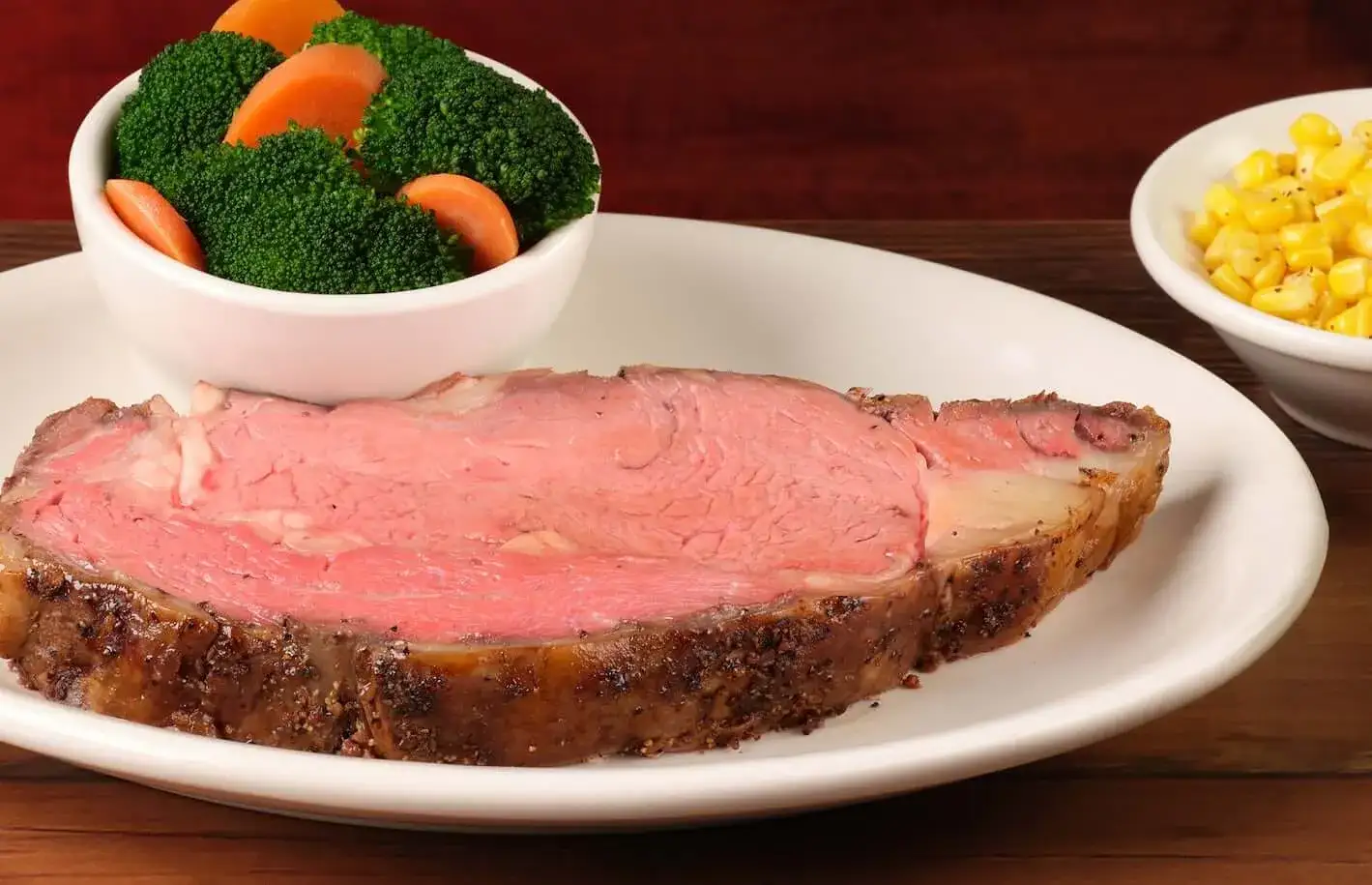 home page 28 Juicy Prime Rib Served on a plate with steamed vegetables